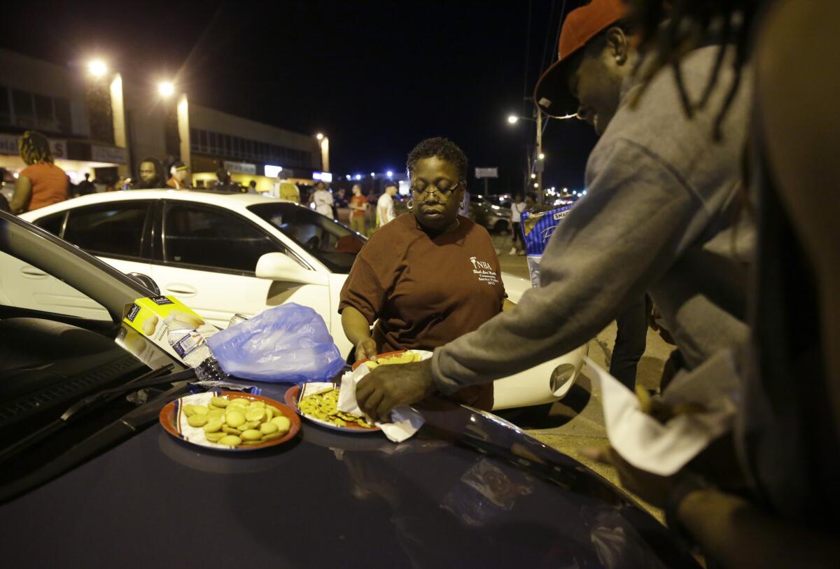 "Momma Cat" Daniels puts out snacks as about 70 protesters gather along West Florissant Avenue in Ferguson, Mo., Tuesday night.