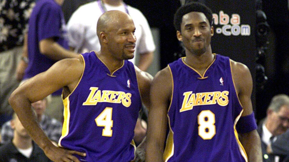 Ron Harper and Kobe share a moment during Game 4 of the Western Conference semifinals game in 2001. (Los Angeles Times)