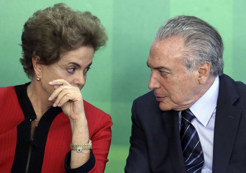 FILE - In this March 2, 2016 file photo, Brazil's President Dilma Rousseff talks with her Vice President Michel Temer at Planalto presidential palace in Brasilia, Brazil. Temer is the first in line to replace Rousseff if she's impeached, but is himself under investigation in the Petrobras corruption scandal. (AP Photo/Eraldo Peres, File)