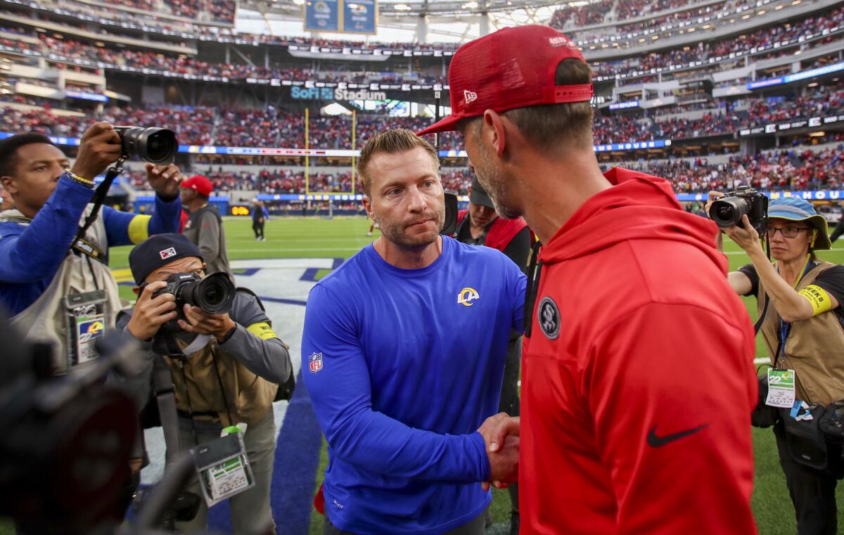 Rams head coach Sean McVay (left) congratulates 49ers head coach Kyle Shanahan.
