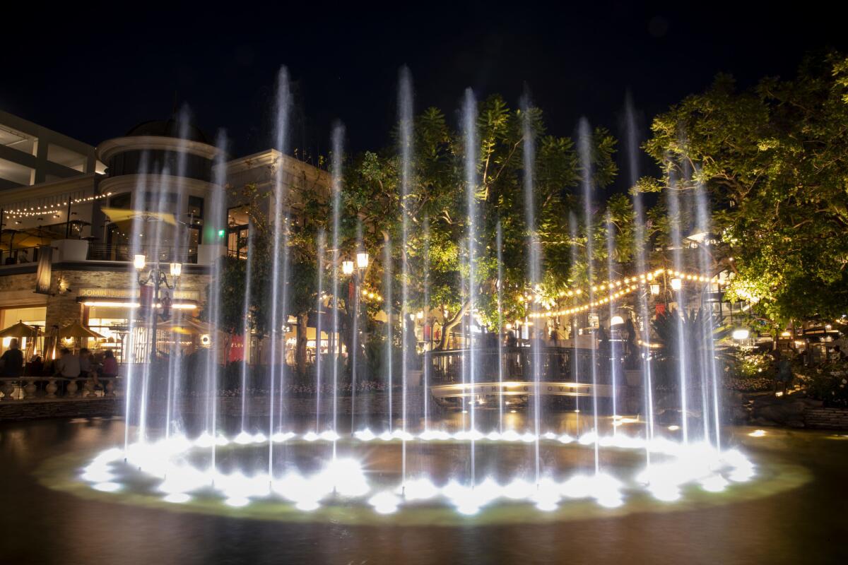 The fountain inside the Grove mall in Los Angeles lights up in June.