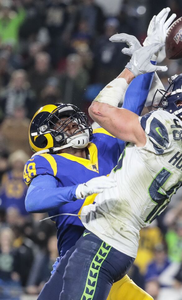 Rams linebacker Travin Howard knocks the ball away from Seattle Seahawks tight end Jacob Hollister.