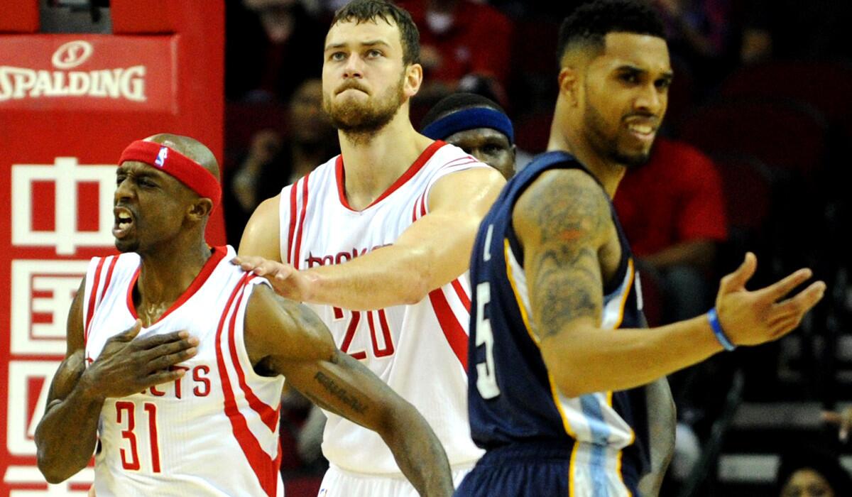 Rockets guard Jason Terry (31) celebrates scoring and drawing a foul with teammate Donatas Motiejunas (20) as Grizzlies guard Courtney Lee questions the call in the first half of their game Wednesday night.