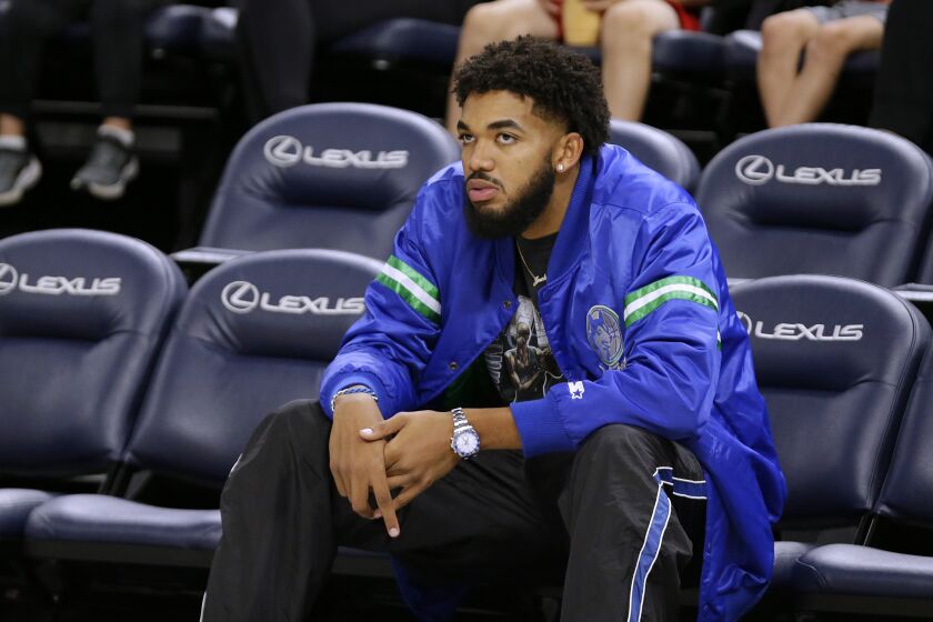 Minnesota Timberwolves forward Karl-Anthony Towns watches from the seats during the NBA basketball team's open practice Saturday, Oct. 1, 2022, in Minneapolis. (AP Photo/Andy Clayton-King)