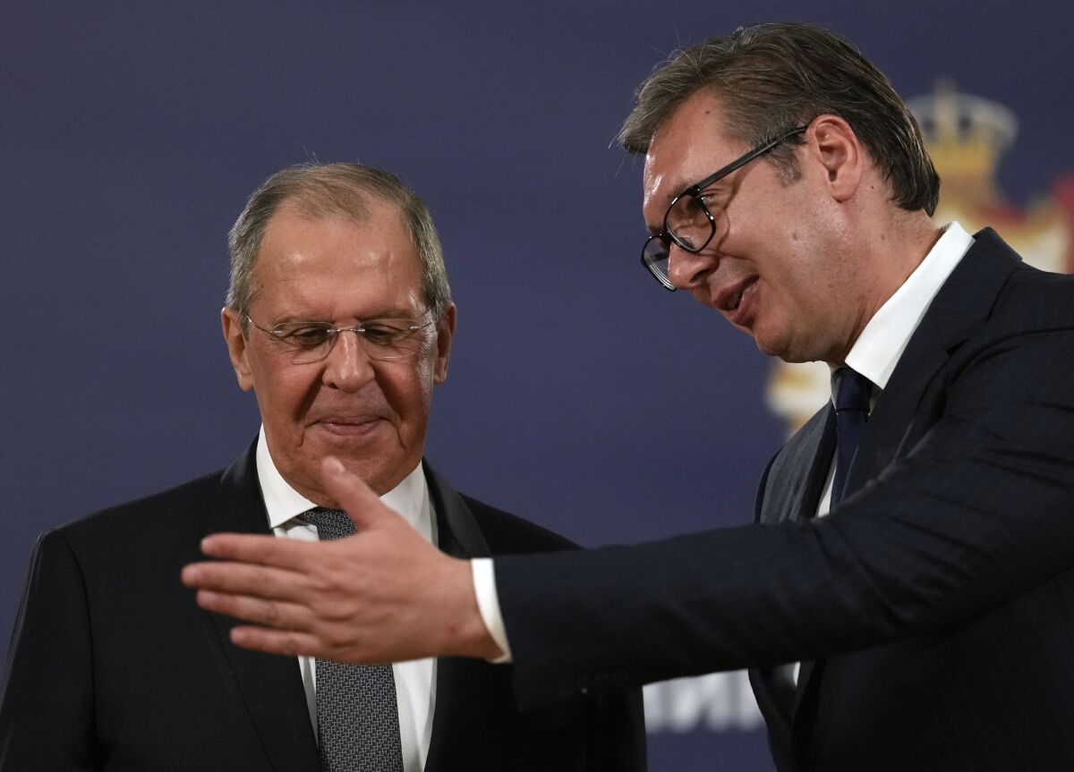 FILE - Russian Foreign Minister Sergey Lavrov, left, speaks with Serbia's President Aleksandar Vucic after a press conference in Belgrade, Serbia, Sunday, Oct. 10, 2021. Serbia says that a planned visit Monday, June 6, 2022 by Russia’s foreign minister to the Balkan country will not take place. The announcement followed reports that Serbia’s neighbors, Bulgaria, North Macedonia and Montenegro refused to allow Sergey Lavrov’s plane to fly through their airspace to reach Serbia. (AP Photo/Darko Vojinovic, File)