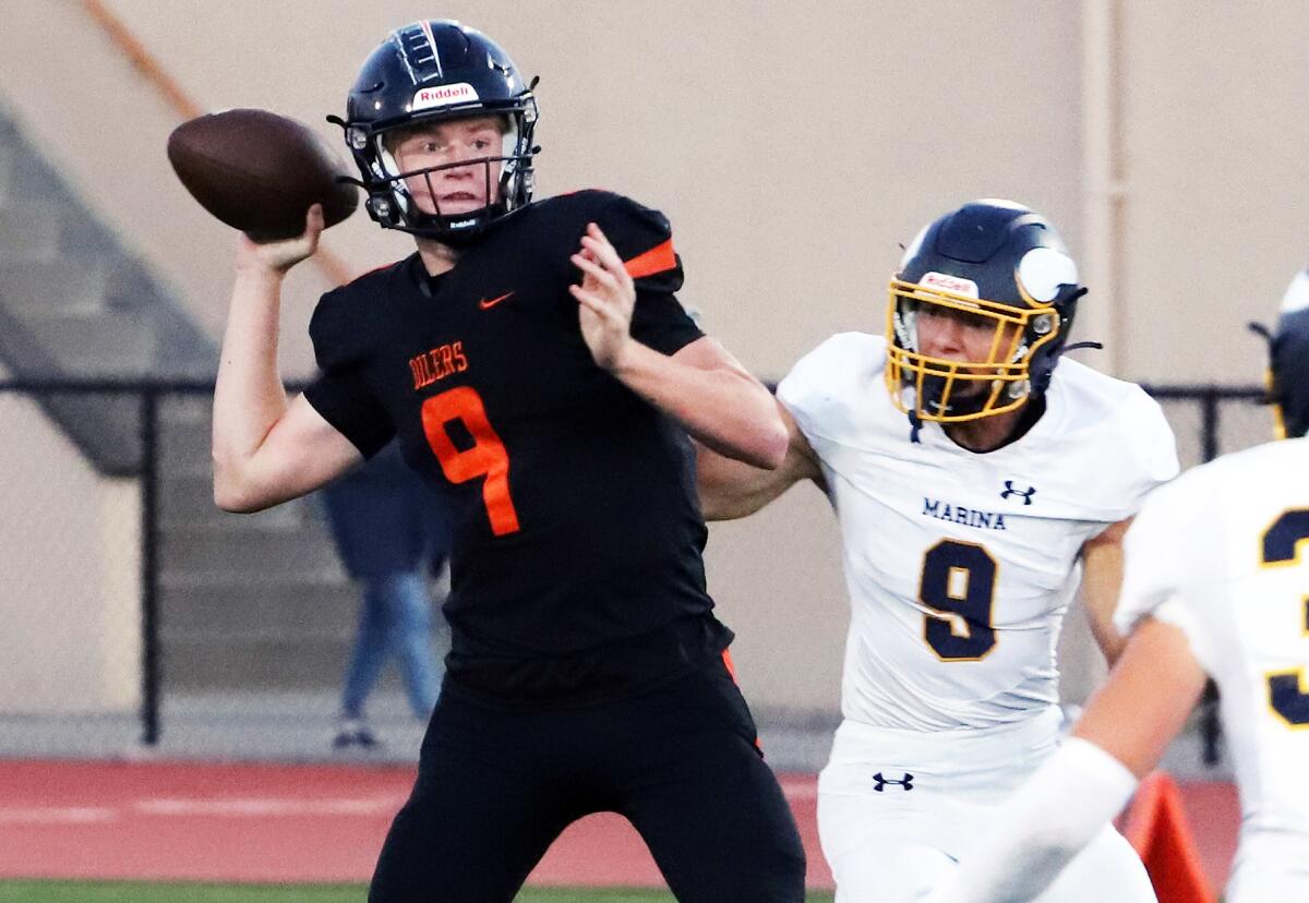 Huntington Beach quarterback Brady Edmunds (6) steps back to pass against Marina on Thursday.