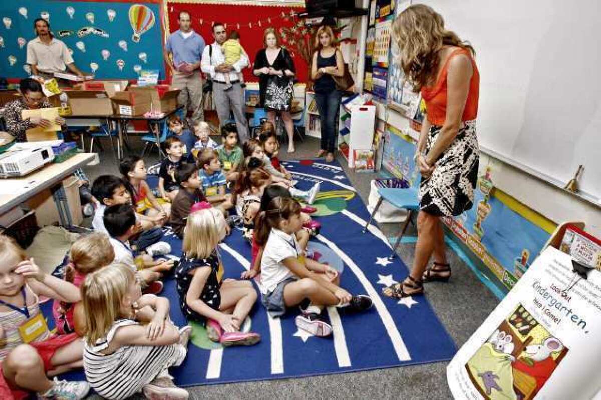 With some anxious parents looking on, La Canada Elementary School kindergarten teacher Becca McLarty, right, greets her class of 22 students during the first day of class on Tuesday, August 28, 2012.