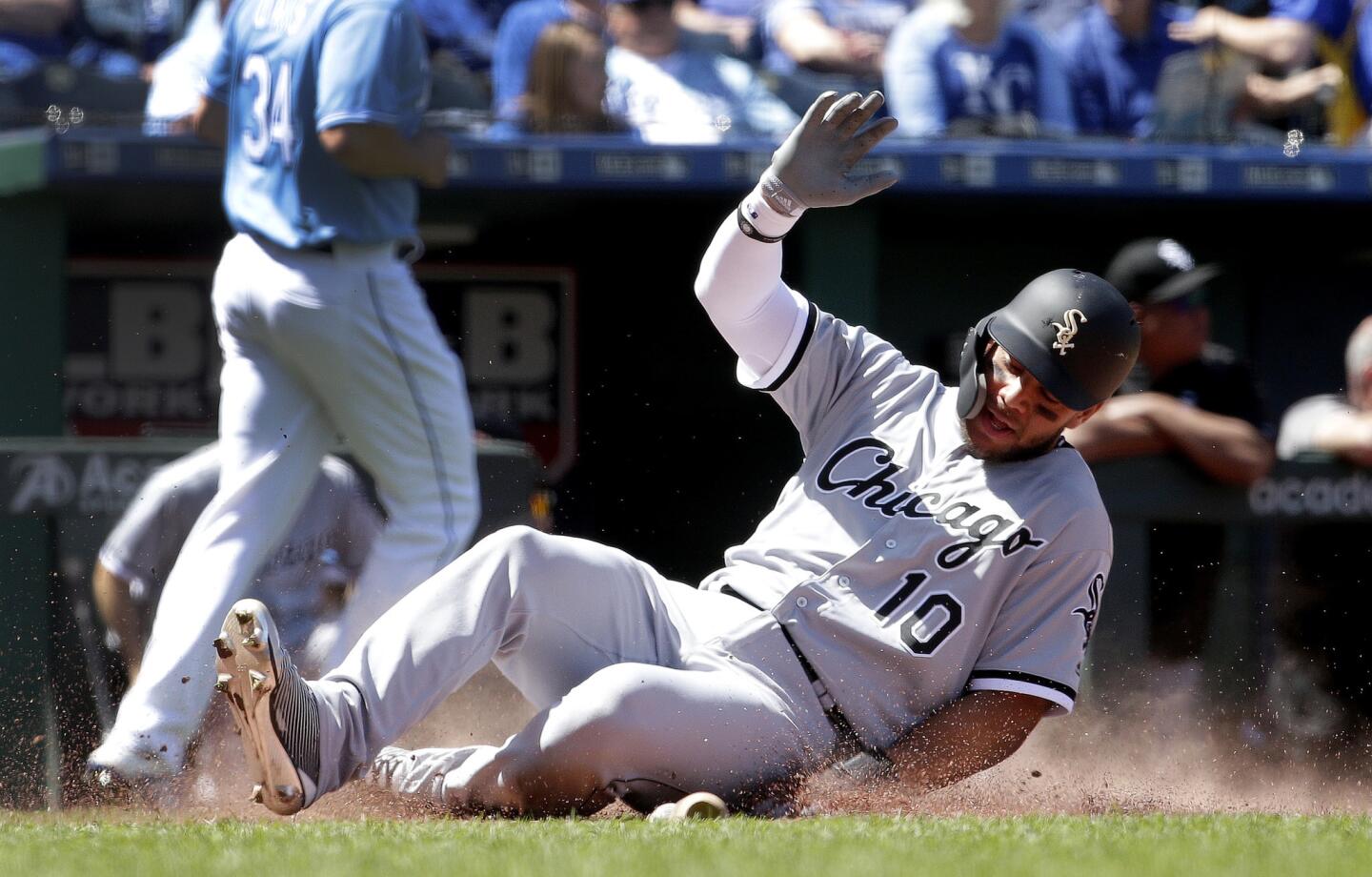The White Sox's Yoan Moncada slides home to score on a double by Yolmer Sanchez during the fourth inning against the Royals Saturday, April 28, 2018, in Kansas City, Mo.