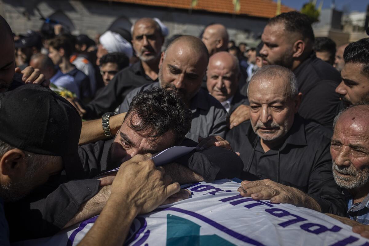 Blida, Lebanon. November 7, 2023. Mohammed Shou, father of Remas, Taleen, and Layan Mahmoud Shor, during the burial of his three daughters in South Lebanon. He returned yesterday from Ivory Coast to bury his three daughters who lost their lives after an Israeli attack.