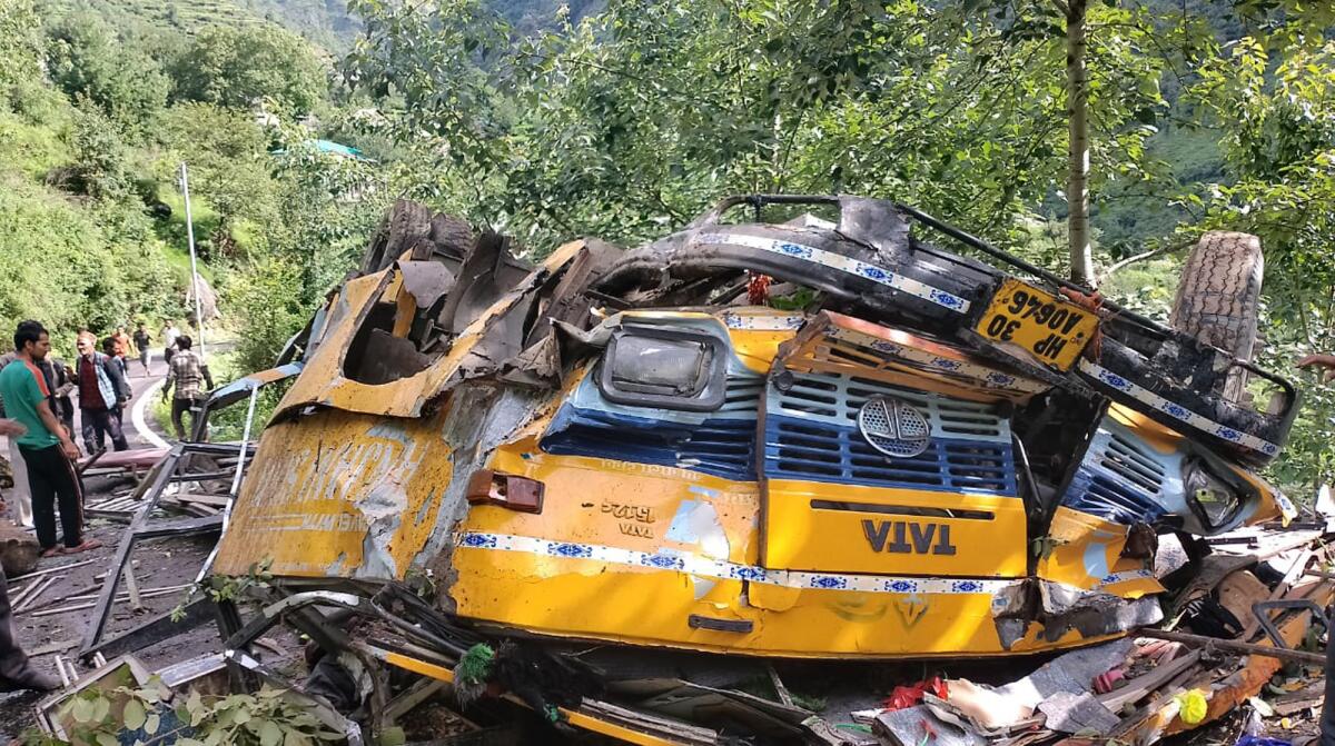This photograph provided by Deputy Commissioner's office, Kullu, shows the wreckage of a passenger that bus slid off a mountain road and fell into a deep gorge near Kullu, Himachal Pradesh state, India, Monday, July 4, 2022. More than a dozen people including schoolchildren were killed in the accident. (Deputy Commissioner's office, Kullu via AP)