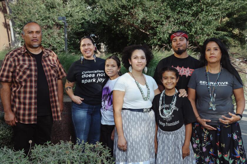 Los Angeles, CA - October 10: Joel Garcia, Kimberly Roberston, Farrah Ramos, Samantha Morales Johnson, Isaac Michael, Elizabeth Recalde and Kimberly Morales Johnson, left to right, pose for a portrait during Indigenous People's Day Celebration at Grand Park on Monday, Oct. 10, 2022 in Los Angeles, CA. Joel Garcia, together with Kimberly Robertson are the artists and founders of Meztli Projects which aims to improve indigenous representation in art. All those photographed here are involved in the project. (Dania Maxwell / Los Angeles Times)