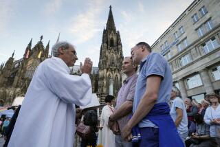 FILE - Same-sex couples take part in a public blessing ceremony in front of the Cologne Cathedral in Cologne, Germany, on Sept. 20, 2023. Pope Francis has formally approved allowing priests to bless same-sex couples, with a new document released Monday Dec. 18, 2023 explaining a radical change in Vatican policy by insisting that people seeking God’s love and mercy shouldn’t be subject to “an exhaustive moral analysis” to receive it. (AP Photo/Martin Meissner, File)