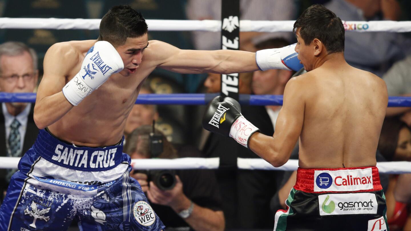 Leo Santa Cruz, left, punches Jose Cayetano during their featherweight fight at MGM Grand in Las Vegas on May 2, 2015.