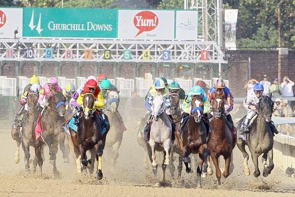 The 138th Kentucky Derby field breaks down the front stretch at the start of the race Saturday at Churchill Downs in Louisville.