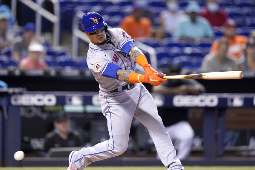New York Mets' Javier Baez strikes out swinging during the first inning of a baseball game against the Miami Marlins, Thursday, Aug. 5, 2021, in Miami. (AP Photo/Lynne Sladky)