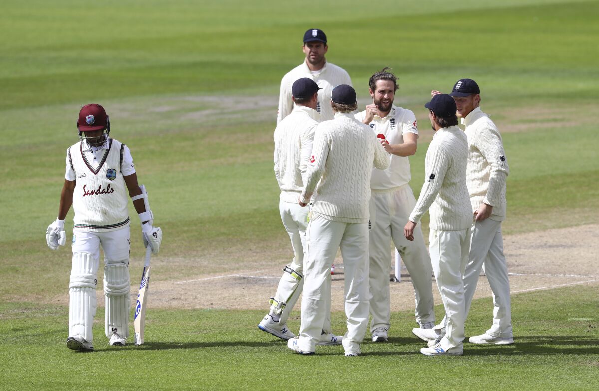 England's Chris Woakes, third right, celebrates with teammates the dismissal of West Indies' Shane Dowrich, left, during the fifth day of the third cricket Test match between England and West Indies at Old Trafford in Manchester, England, Tuesday, July 28, 2020. (Michael Steele/Pool via AP)