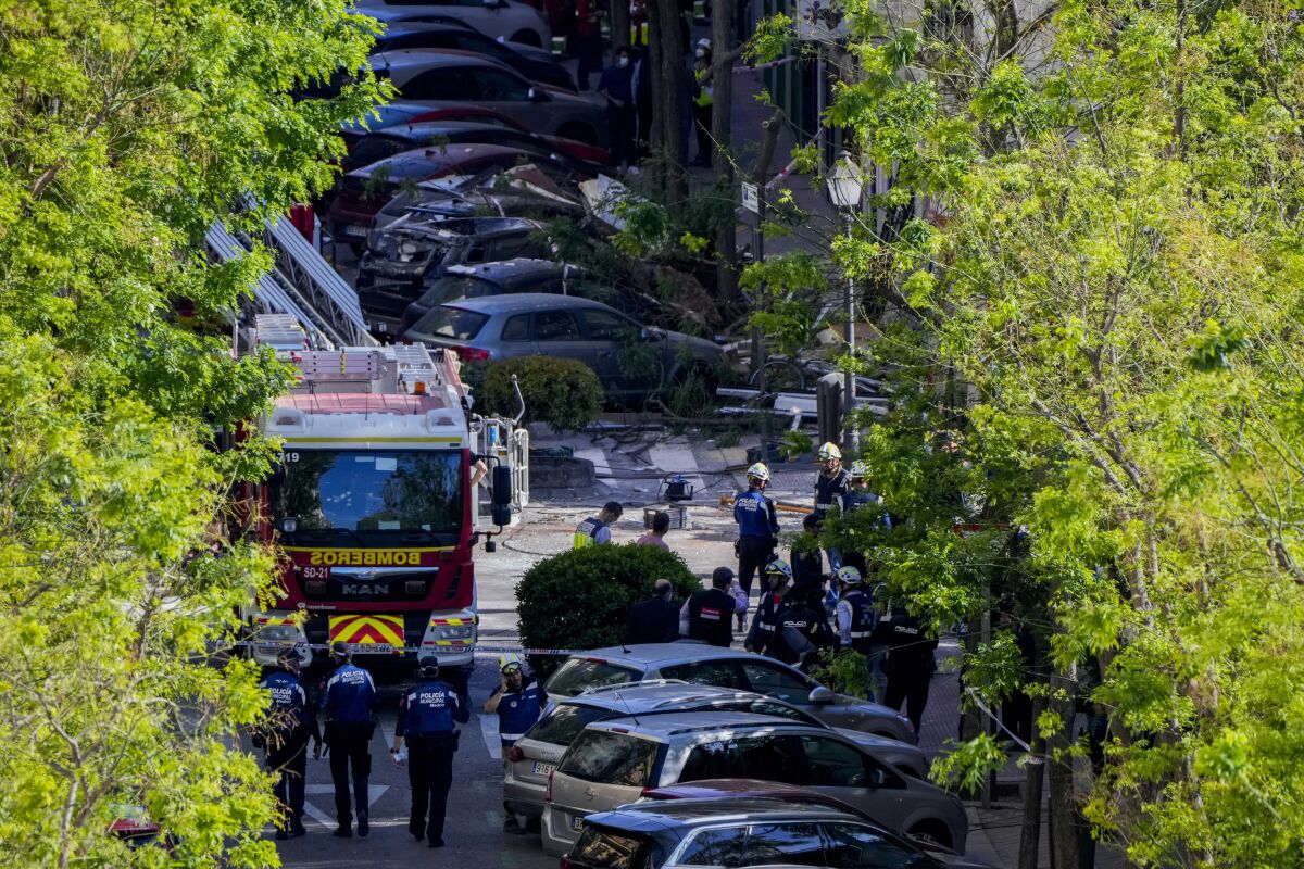 Members of emergency team work on a damaged area following an explosion in Madrid, Spain, Friday, May 6, 2022. An explosion ripped through a four-story residential building in central Madrid on Friday, killing two and injuring at least 18 people. (AP Photo/Manu Fernandez)