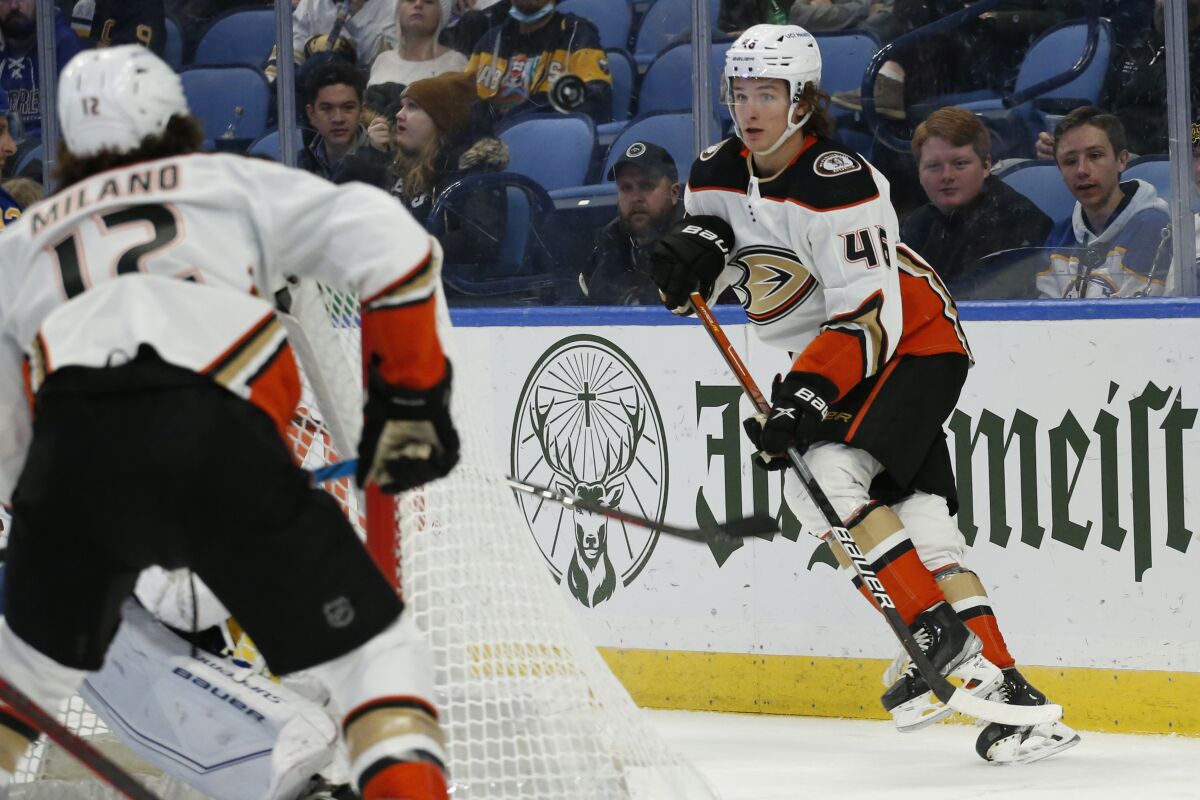 Anaheim Ducks center Trevor Zegras (46) passes the puck from behind the net during the second period of an NHL hockey game against the Buffalo Sabres, Tuesday, Dec. 7, 2021, in Buffalo, N.Y. (AP Photo/Jeffrey T. Barnes)