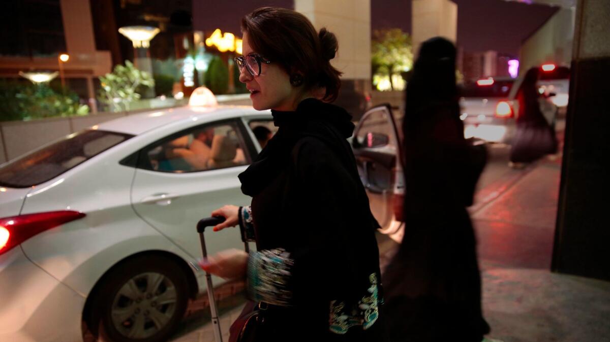 In 2015, a woman waits for an Uber ride in Riyadh, Saudi Arabia. Since women are not allowed to drive, hiring cars has been one of their few options.