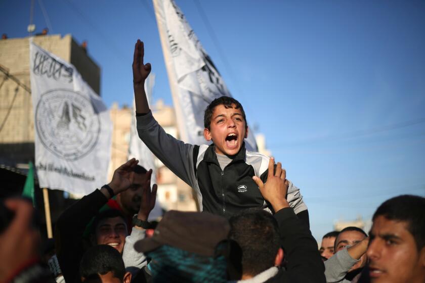 A Palestinian boy shouts slogans Feb. 5 during a rally near the Rafah border between southern Gaza Strip and Egypt to condemn the decision of an Egyptian court to ban the armed wing of Hamas.