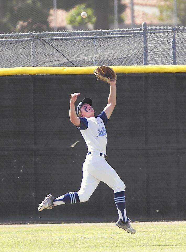 A double flies over the head of Corona del Mar High center fielder Brenden Hueston against Woodbridge on Tuesday.