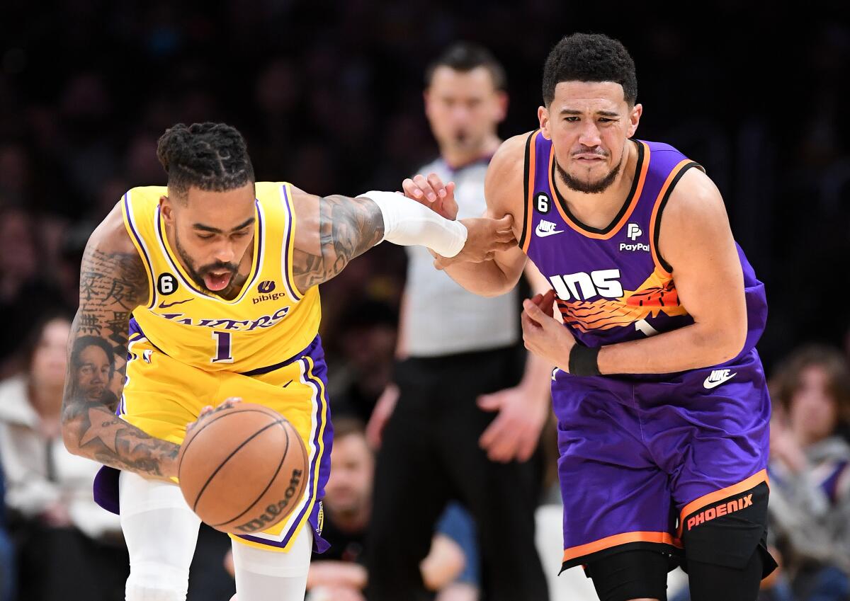 The Lakers' D'Angelo Russell steals the ball from the Suns' Devin Booker in the fourth quarter Wednesday night.