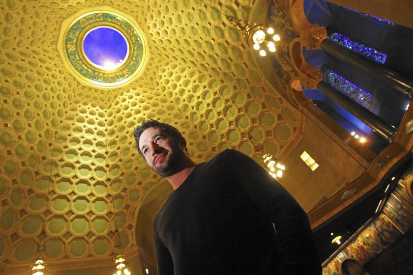 Aaron Wolf poses in the sanctuary of the Wilshire Boulevard Temple in Los Angeles. His documentary "Restoring Tomorrow" tells about the restoration of the temple.