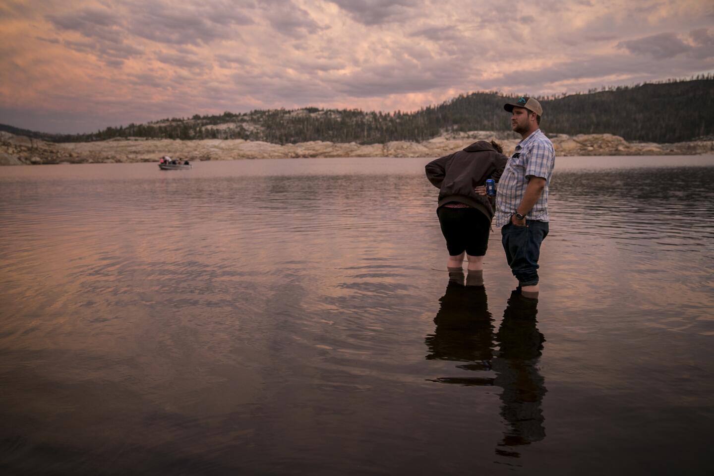 Farmer Robert Godfrey and his wife, Sarah, cool off in the low waters of Spicer Meadow Reservoir.