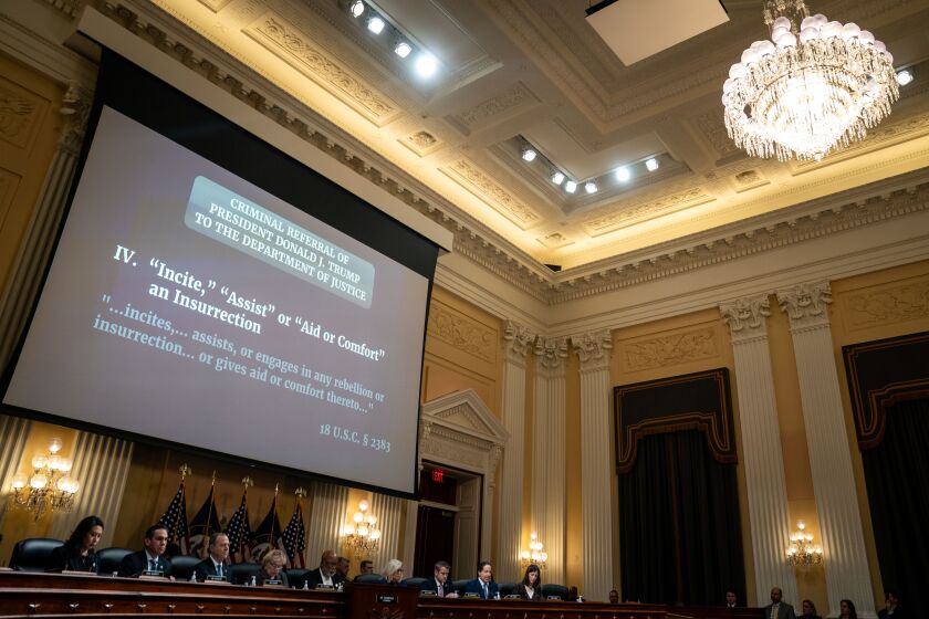 WASHINGTON, DC - DECEMBER 19: "Criminal Referral Of President Donald J. Trump To The Department Of Justice" is displayed on a screen as the House Select Committee to Investigate the January 6th Attack on the United States Capitol conducts its final hearing in the Cannon House Office Building on Monday, Dec. 19, 2022 in Washington, DC. The bipartisan Select Committee to Investigate the January 6th Attack On the United States Capitol has spent over a year conducting more than 1,000 interviews, reviewed more than 140,000 documents day of the attack. (Kent Nishimura / Los Angeles Times)