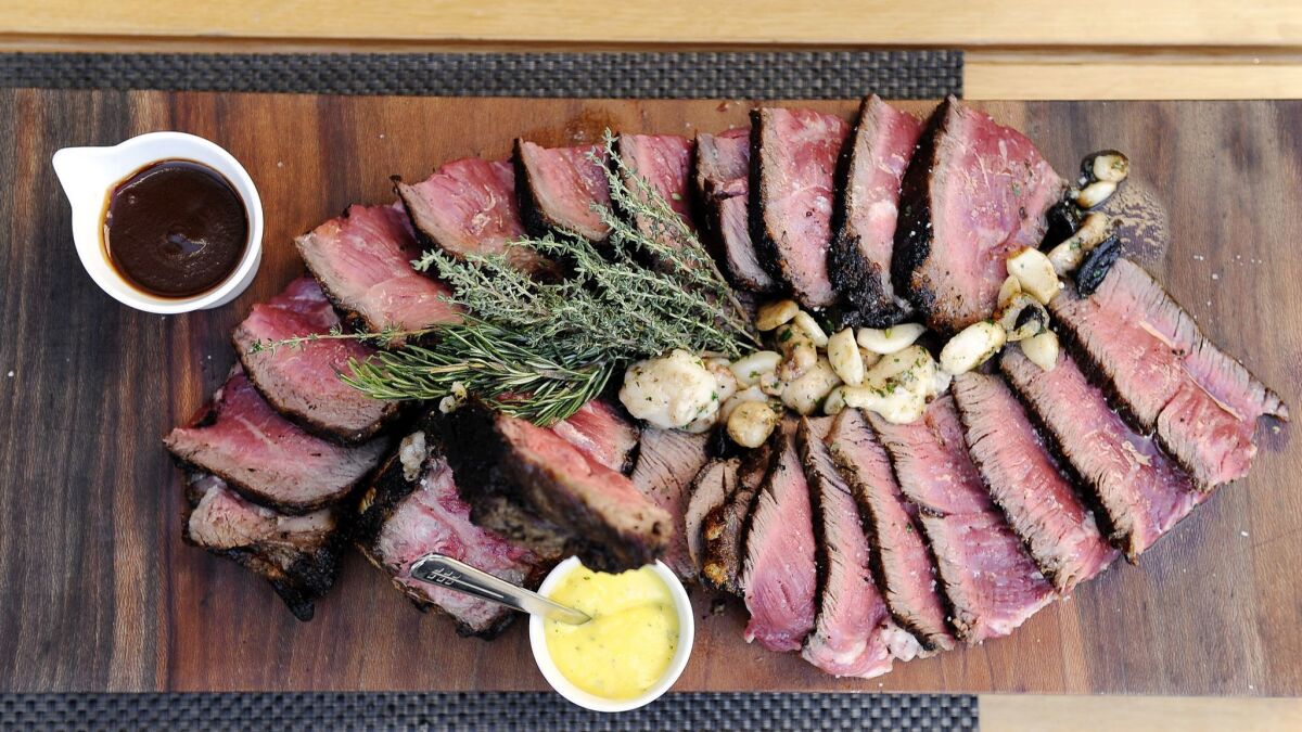 A 34-ounce Porterhouse with black and golden caramelized garlic, roasted bone marrow and parsley at CUT in Beverly Hills.