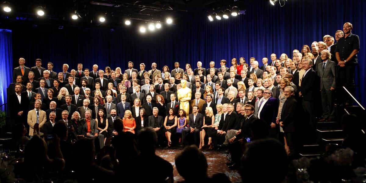 Nominees for the 2013 Academy Awards pose for a group portrait in February. To vote on next year's nominees, academy members are being urged to re-register for a new website that the organization hopes will reduce problems with online voting. Members also have a choice of selecting a paper ballot over an electronic one.