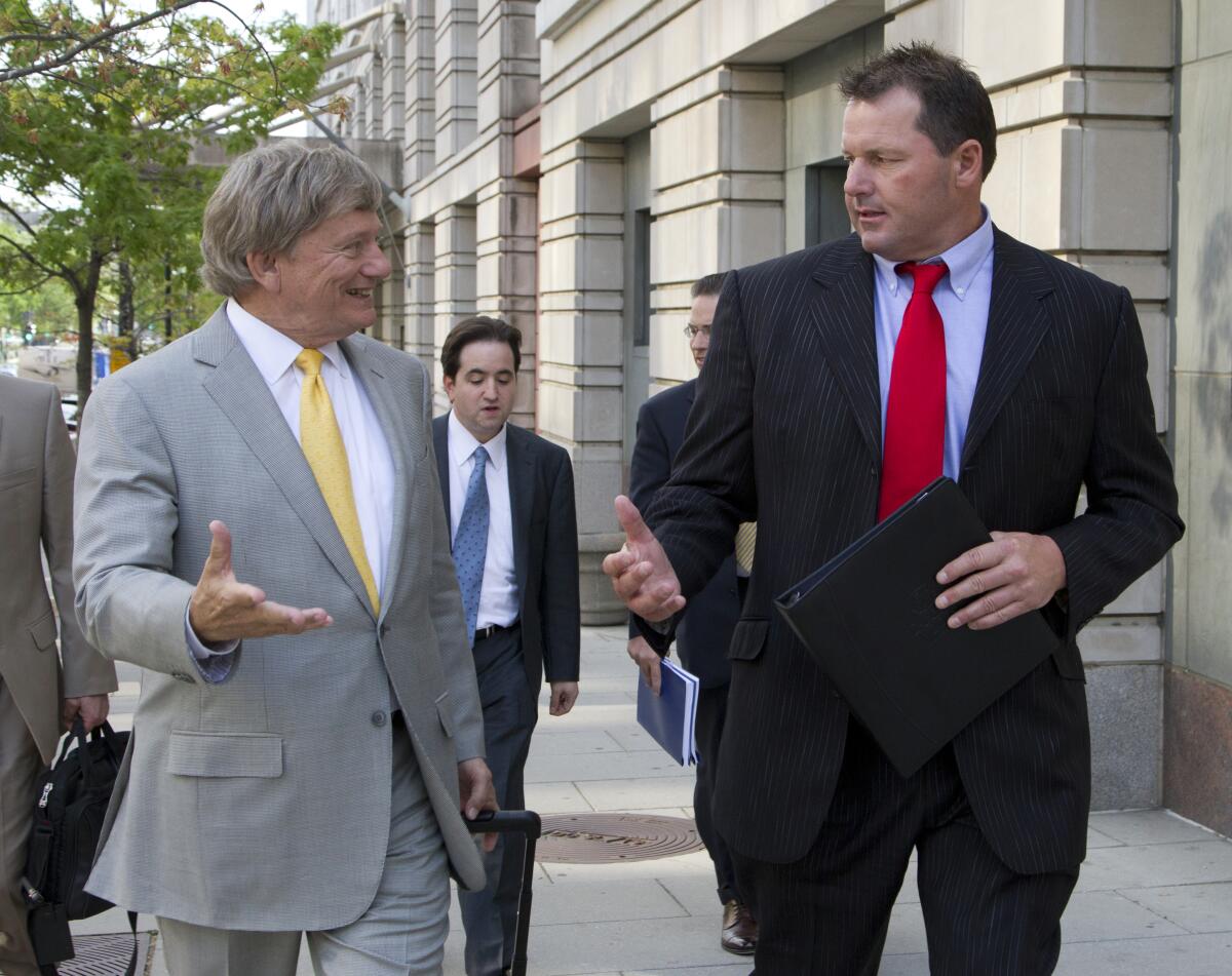 Roger Clemens, right, and lawyer Rusty Hardin leave federal court in Washington on April 17, 2012.