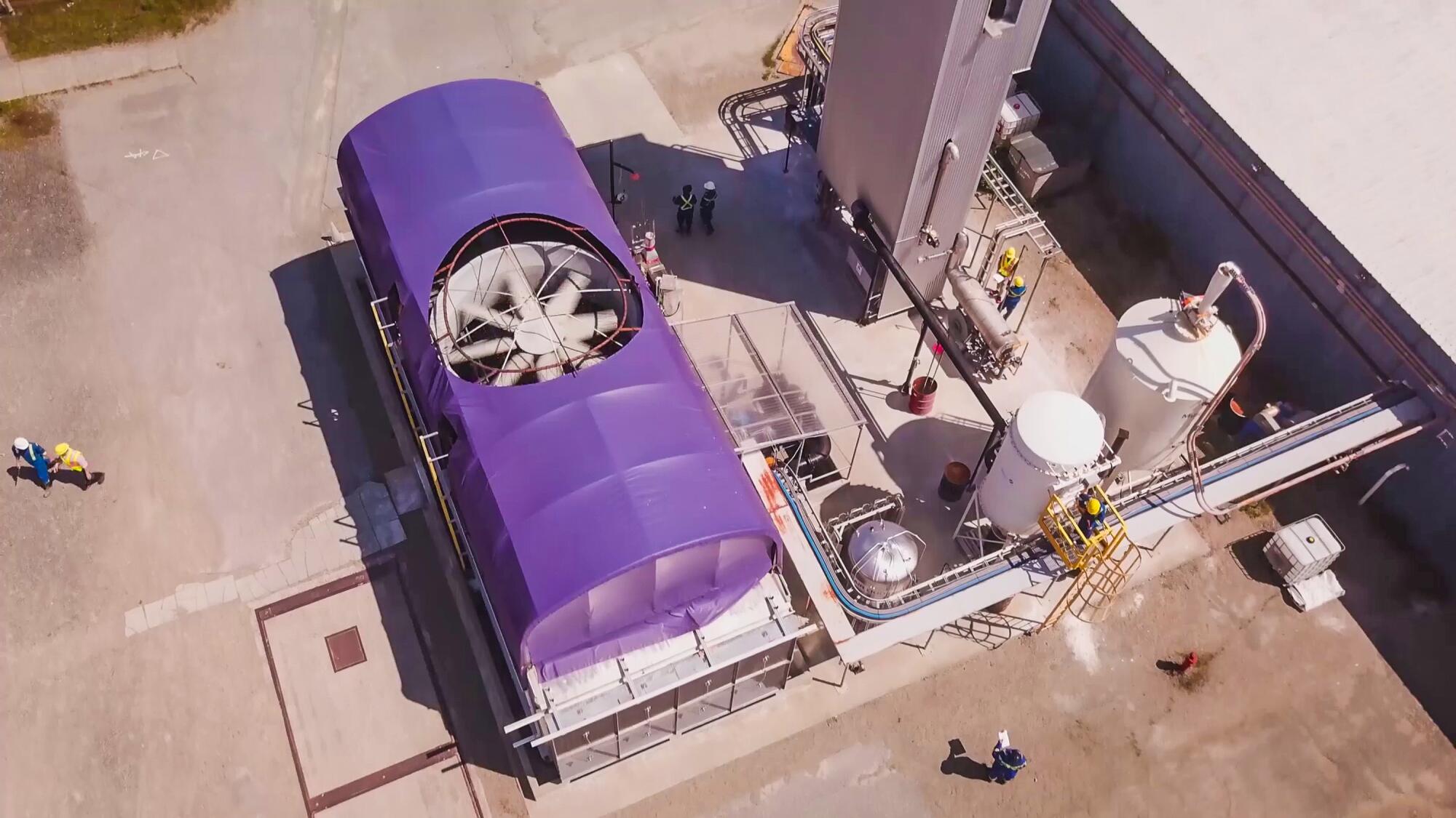 A giant fan is visible in an aerial view of an industrial plant.
