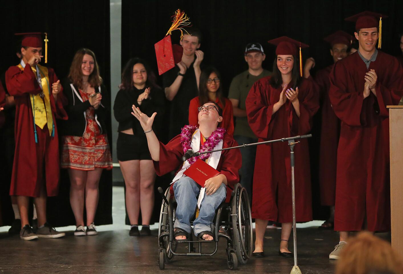 Max Nelson throws his cap in the air as he is announced officially graduated from Ocean View High School during a special ceremony Friday. Nelson missed the scheduled graduation June 12 because of a fall that sent him to a hospital an hour before the ceremony. Friday's proceedings included speakers, recent graduates, school board members, friends, relatives and administrators.