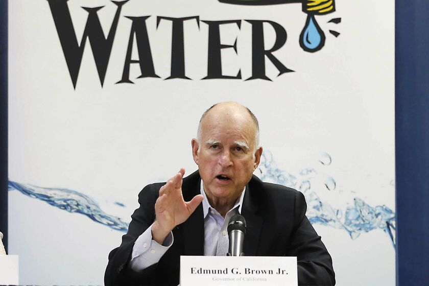 Gov. Jerry Brown talks with reporters in April after a meeting about the drought at his Capitol office in Sacramento.