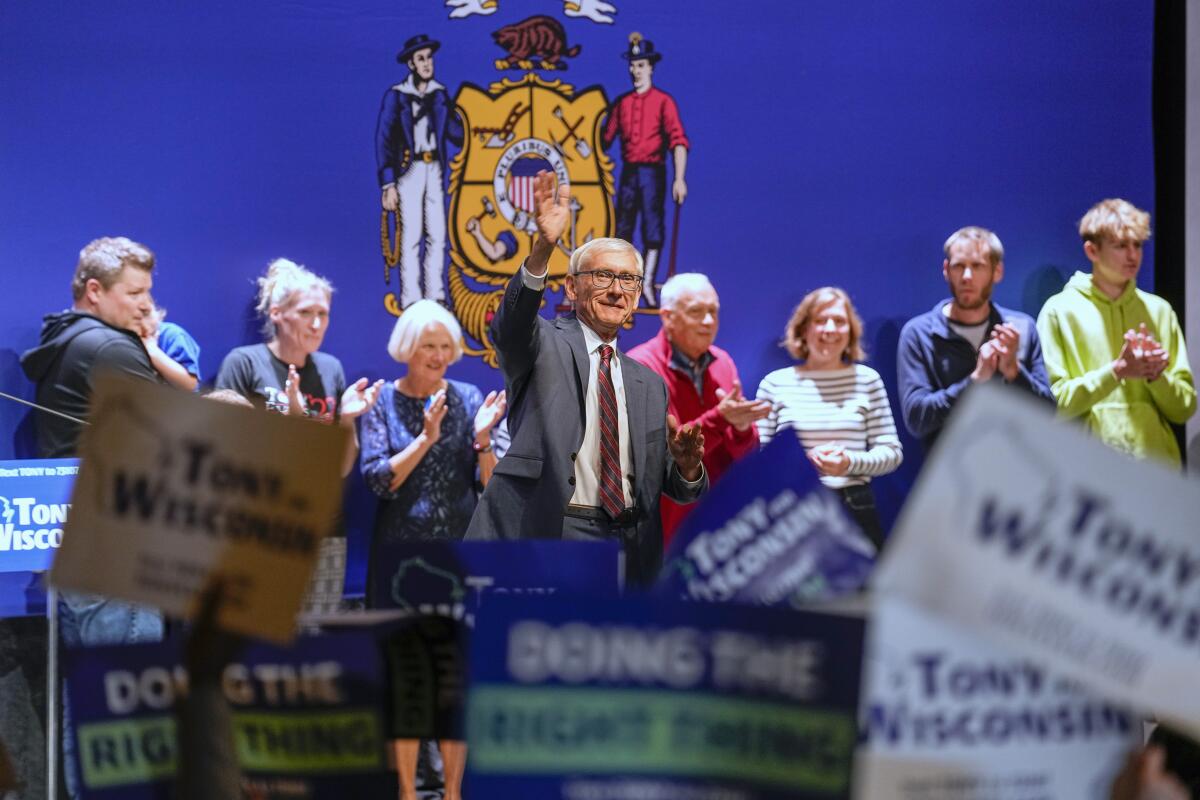 Wisconsin Gov. Tony Evers waves to his fans Wednesday, Nov. 9, 2022, in Madison, Wis., after beating businessman Tim Michels in Tuesday's governorship election. (AP Photo/Andy Manis)