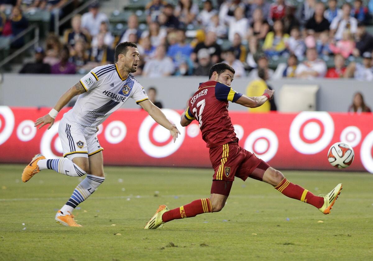 The Galaxy's Dan Gargan chases Real Salt Lake's John Stertzer, right, during the first half of a match on July 12.