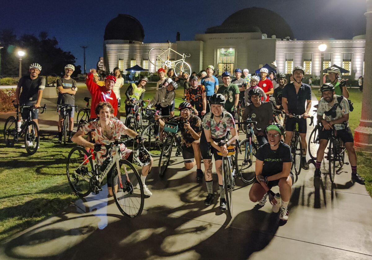 People posing with bikes