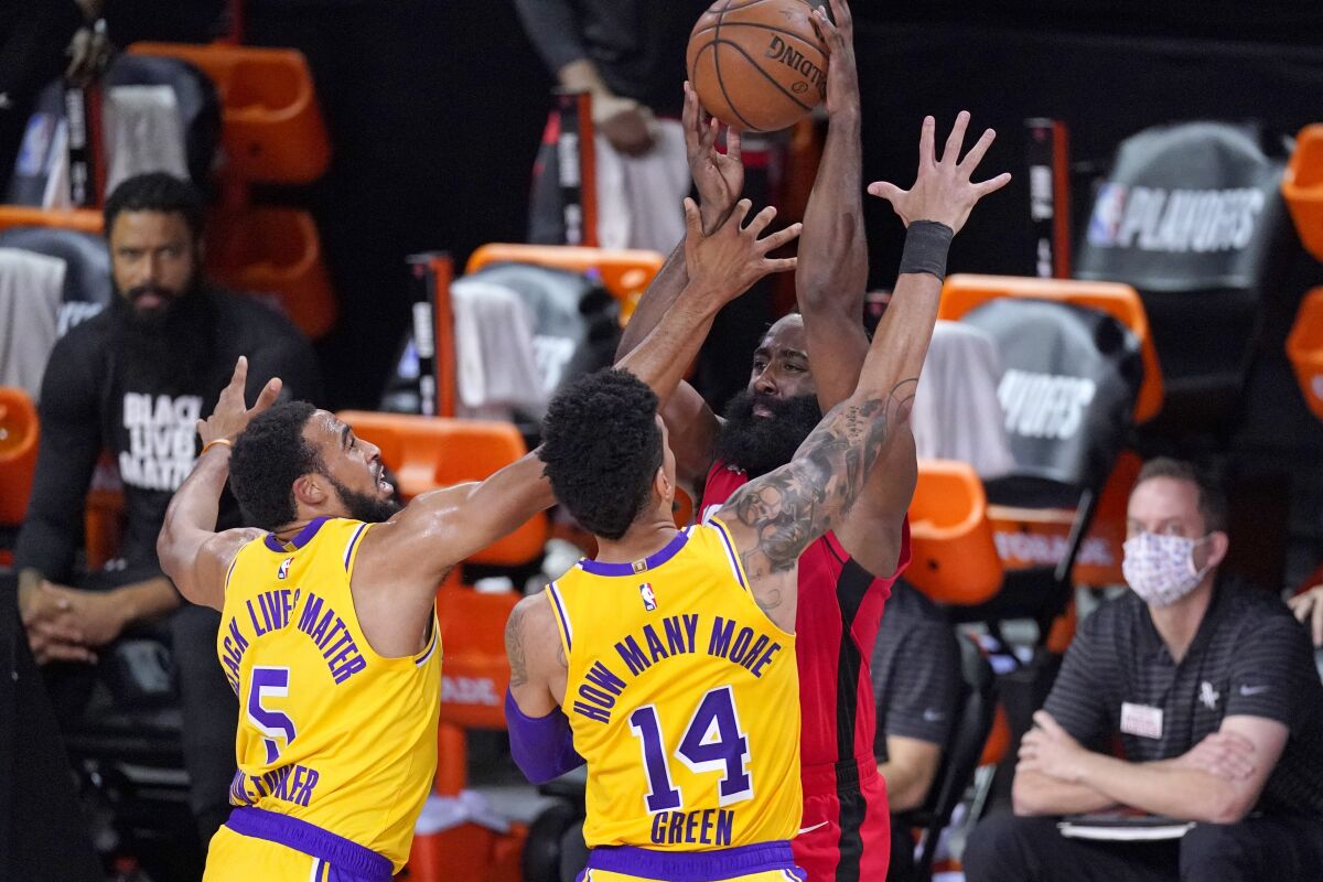 Lakers guards Talen Horton-Tucker (5) and Danny Green (14) trap Rockets star James Harden during Game 4 on Sept. 10, 2020.