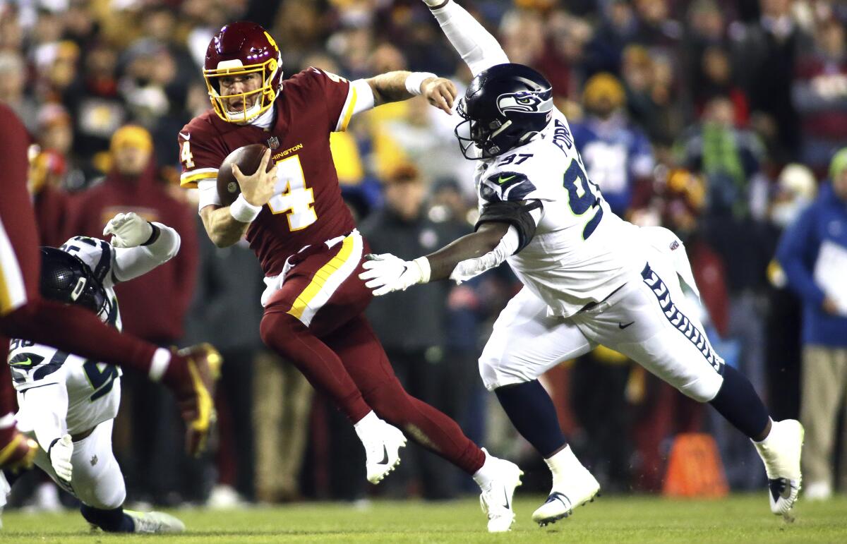 Washington Football Team quarterback Taylor Heinicke runs against the Seattle Seahawks.