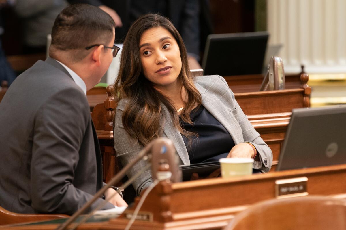 Assemblywoman Sabrina Cervantes (D-Riverside) talks with Assemblyman Rudy Salas (D-Bakersfield) during floor session at the state Capitol in August. 