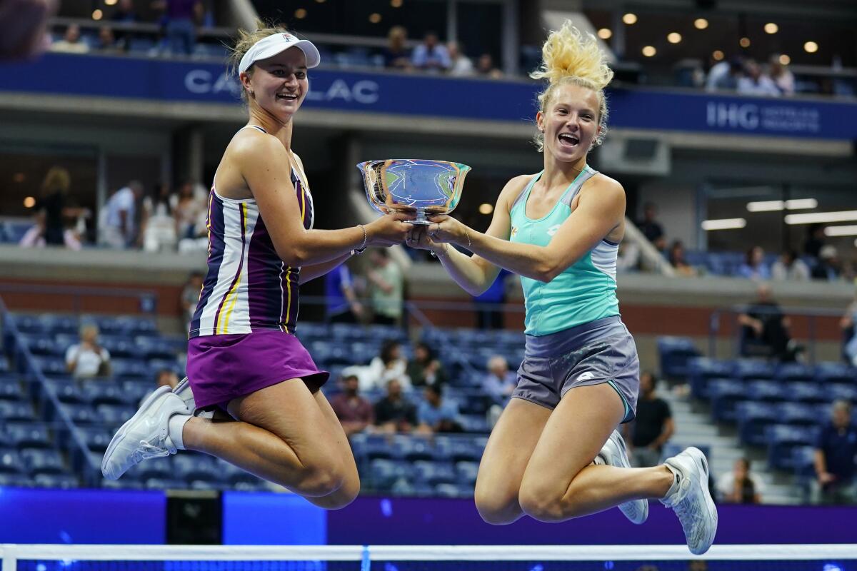 Barbora Krejcikova, of the Czech Republic, left, and Katerina Siniakova, of the Czech Republic jump with the trophy after defeating Taylor Townsend, of the United States, and Caty McNally, of the United States, in the final of the women's doubles at the U.S. Open tennis championships, Sunday, Sept. 11, 2022, in New York. (AP Photo/Matt Rourke)