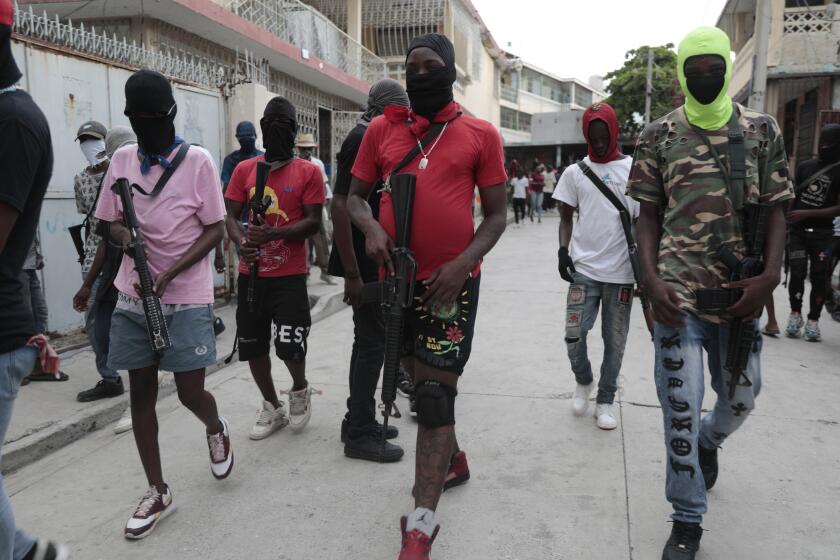 Armed members of "G9 and Family" march in a protest against Haitian Prime Minister Ariel Henry in Port-au-Prince, Haiti, Tuesday, Sept. 19, 2023. (AP Photo/Odelyn Joseph)