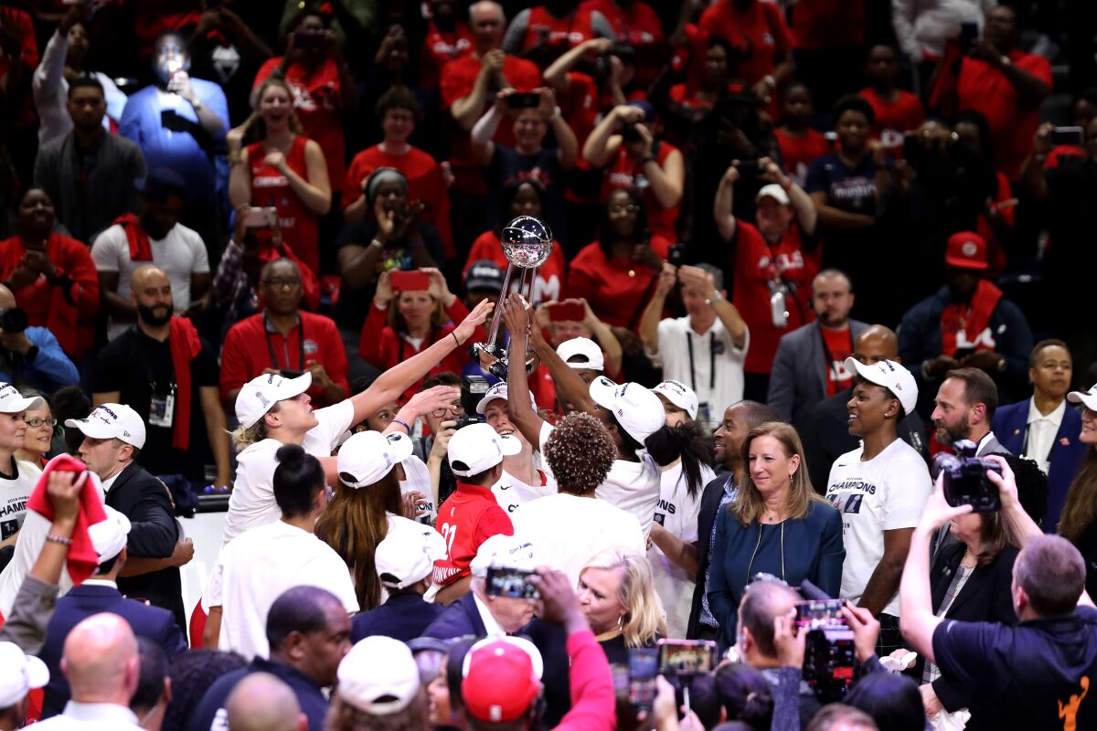 Members of the Washington Mystics celebrate after defeating the Connecticut Sun to win the  2019 WNBA Finals on Oct. 10.