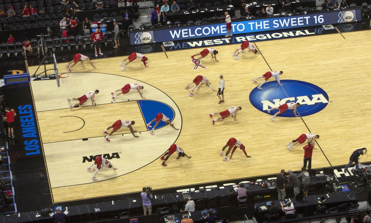 Wisconsin players stretch on the court during practice on Wednesday at Staples Center, the day before their NCAA tournament West Regional game against the North Carolina Tar Heels.