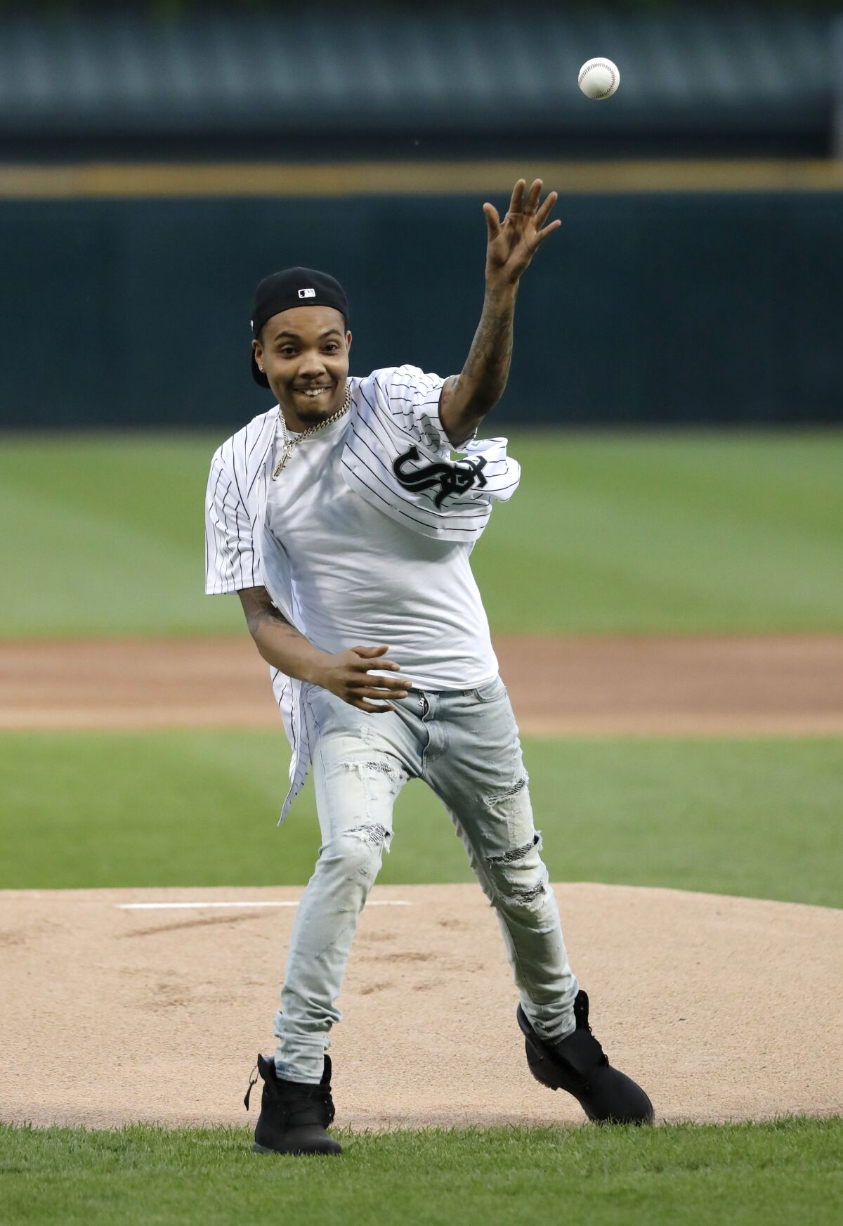 FILE — This June 11, 2019 file photo, Chicago rapper G Herbo throws a ceremonial first pitch before a baseball game between the Chicago White Sox and the Washington Nationals in Chicago. Federal prosecutors announced Wednesday, May 5, 2019 that the Chicago native, whose real name is Herbert Wright III, was charged with lying to federal investigators. In December, the 25-year-old G Herbo was among six people, including his promoter, indicted for conspiracy to commit wire fraud and aggravated identity theft. (AP Photo/Charles Rex Arbogast, File)