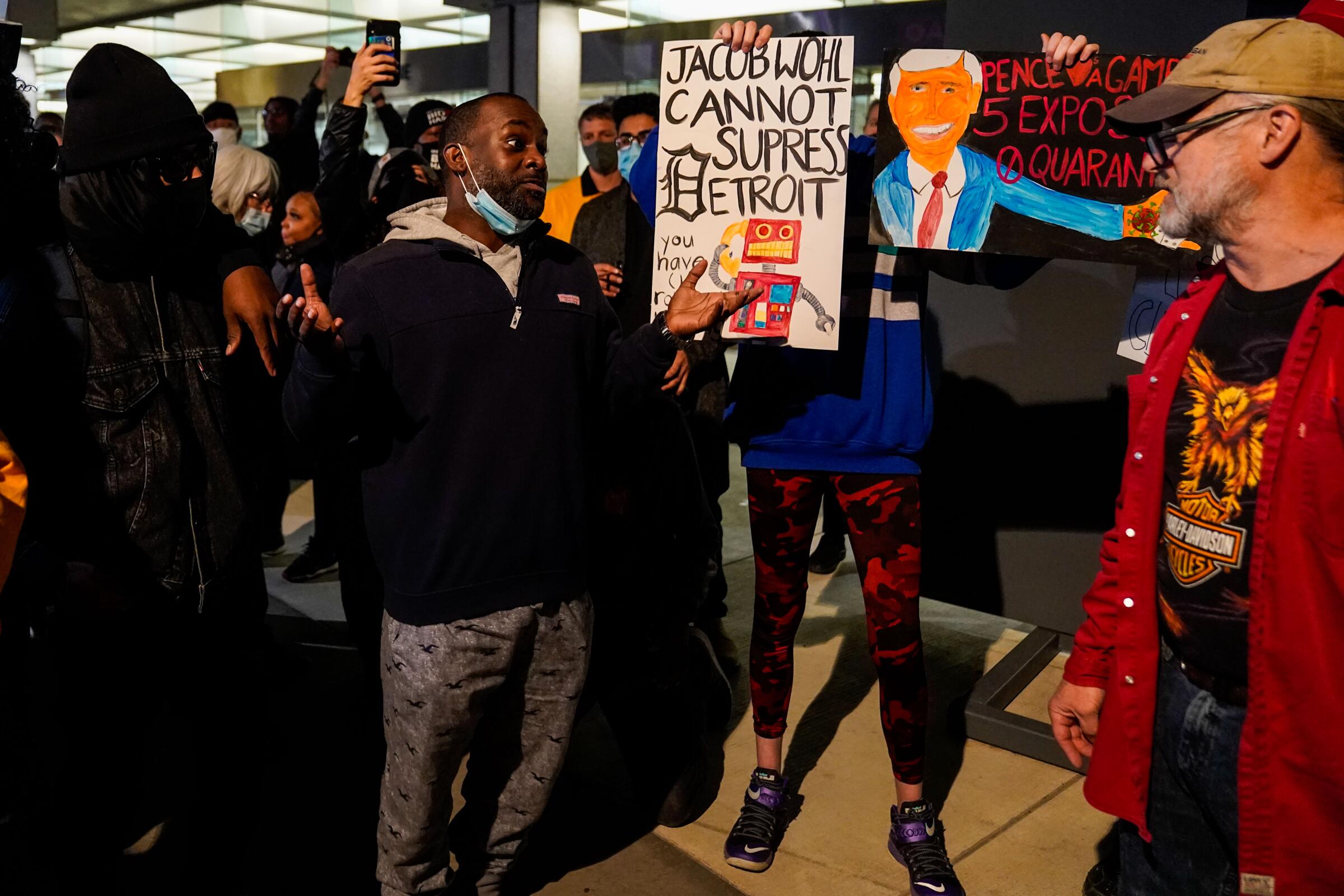 Maceo Rhodes of Detroit talks with a supporter of Donald Trump