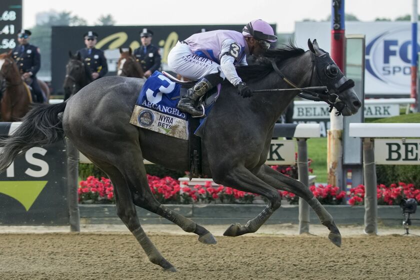 Arcangelo, with jockey Javier Castellano, crosses the finish line to win the Belmont Stakes.