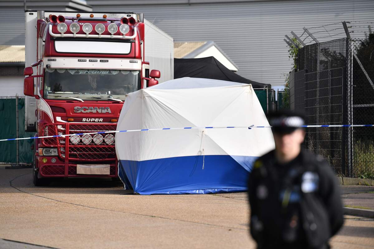 A police officer secures the scene where a truck containing 39  bodies was discovered at Waterglade Industrial Park in Grays, east of London, on Wednesday.