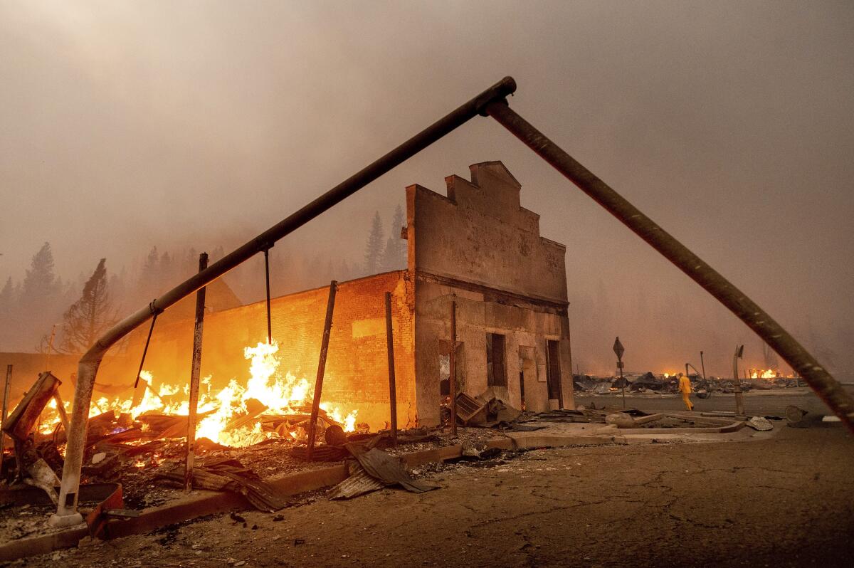 A fire burns next to a destroyed building in Greenville